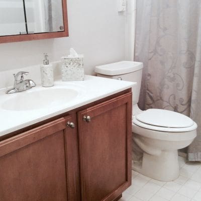 After painting, decreasing the visual noise of wall art and counter items, the small bathroom looks more like a hotel bathroom than a kid's bathroom.