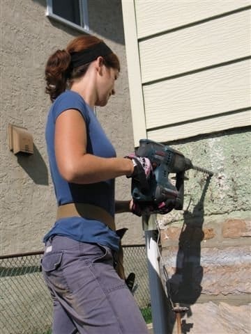 Theresa is getting started on building a deck. (Yes, she's not just posing for the photo.)