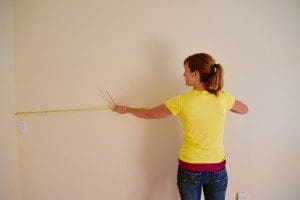Theresa taking measurements for the wainscoting and chair rail.