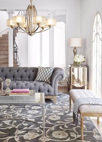 ‣ MyFixitUpLife Parisian pied-a-terre, city apartment living room mixes metals of brass in the chandelier with nickel in the coffee table.