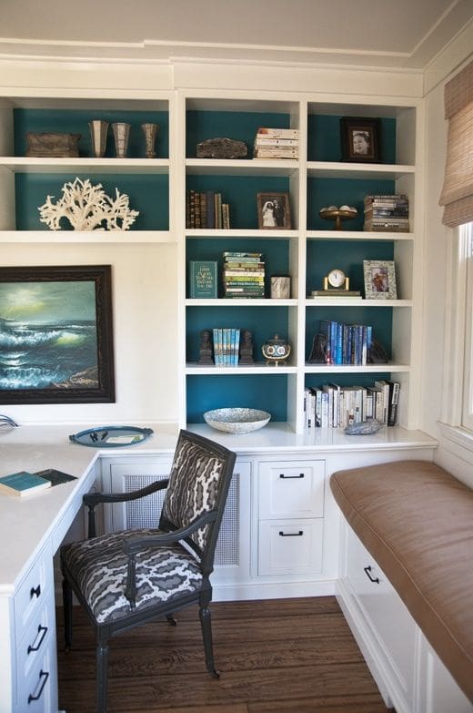 ‣ MyFixitUpLife The blue pops on the backs of these shelves help to give vibrancy to this home office. The cushioned window seat might be your pet's favorite new spot, too.