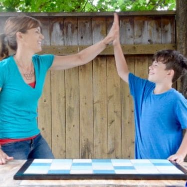 Theresa and Jack high five after finishing a Tile Doormat | Habitat ReStore | MyFixitUpLife