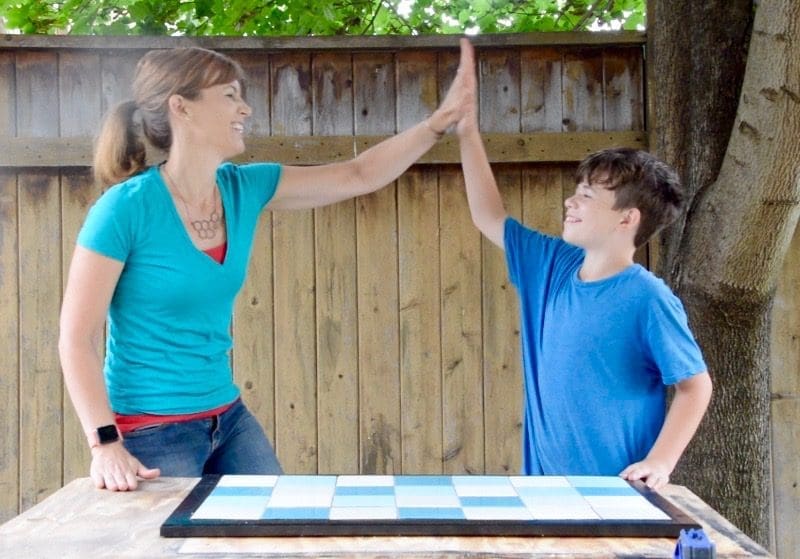 Theresa and Jack high five after finishing a Tile Doormat | Habitat ReStore | MyFixitUpLife